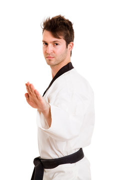 Young man practicing martial arts over white background