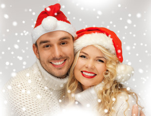 family couple in sweaters and santa's hats