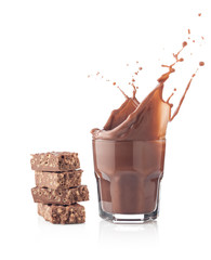 Chocolate splash in a glass with chocolate tablet