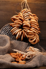 tasty bagels and spikelets on wooden background