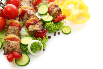 tasty grilled meat and vegetables on skewers, isolated on white