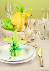 Table setting in green and yellow tones on color  background