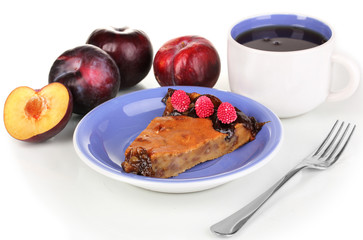 Tasty pie on blue plate with plums isolated on white