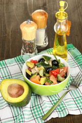 Tasty avocado salad in bowl   surrounded by spices