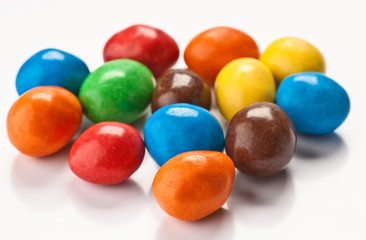 group of colored chocolate balls, on white base