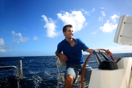 Smiling young sailor navigating in Caribbean sea