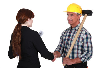 Female architect greeting builder