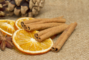 Cinnamon sticks,anise  and dried orange on hessian