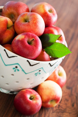 Fresh ripe apples in ceramic colander, selective focus