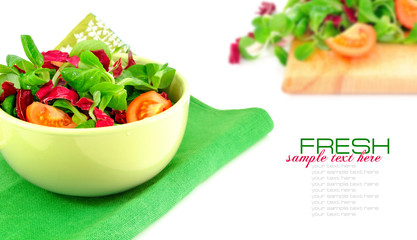 Fresh salad is in a dish on a white background