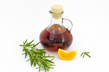 Bottle of liquor with rosemary & mandarin segment
