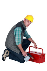 Workman with a blowtorch and toolbox