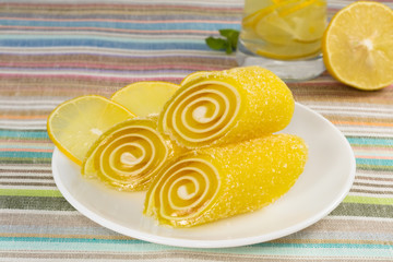 yellow candy fruit on a plate with lemon