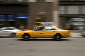 Blurred taxi speeding on city street