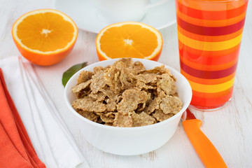 cereals in the bowl with orange and orange juice