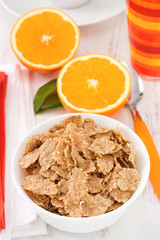 cereals in the white bowl with oranges