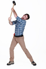 Man using sledge-hammer