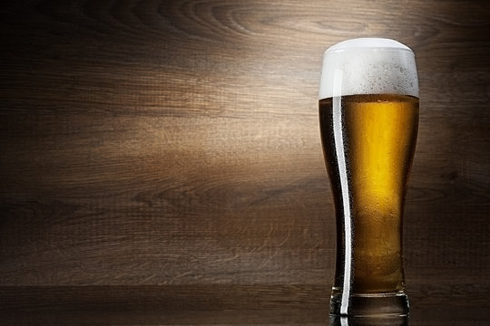 glass beer on wood background with copyspace