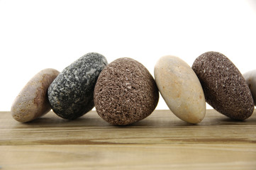 Several different stones isolated over wood board