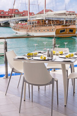 Table settings at restaurant on island's seaside with lagoon and