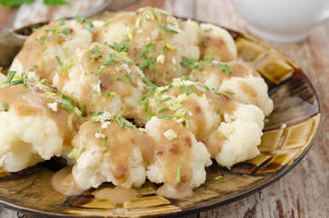 boiled cauliflower with sauce closeup