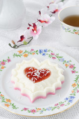 two-layer dessert of cream and jam and coconut on a plate