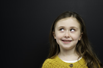 Smart young girl stood infront of a blackboard