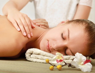 Fototapeta na wymiar An attractive young woman receiving massage
