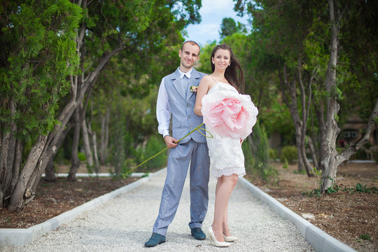 bride and groom posing in the park