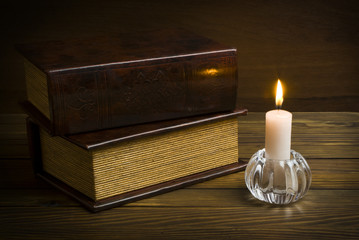 ancient books with candle