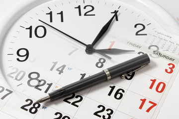 Pen on Calendar and Clock