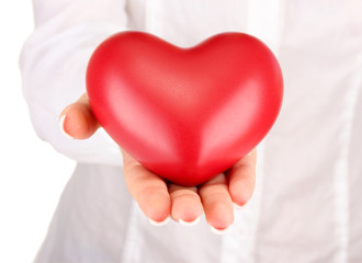 Red heart in woman's hand, on white background close-up