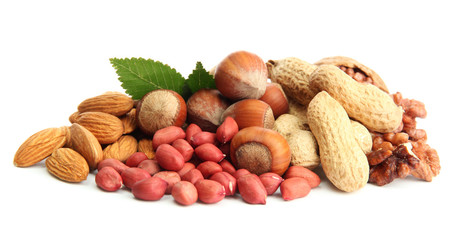 assortment of tasty nuts with leaves, isolated on white