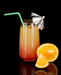 Glass of multicolor cocktail isolated on black