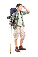 Full length portrait of a hiker with backpack looking