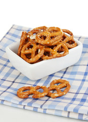 Tasty pretzels in white bowl isolated on white