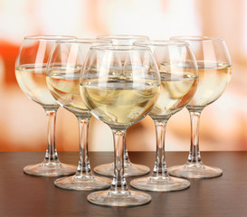 White wine in glass on room background