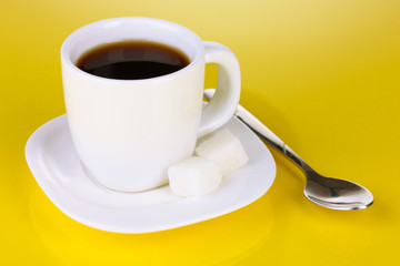 A cup of strong coffee on yellow background