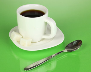 A cup of strong coffee on green background