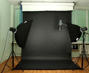 Empty photo studio with lighting equipment