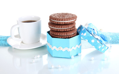 Chocolate cookies with creamy layer and cup of coffe isolated