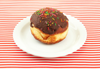 Tasty donuts on color plate on color background