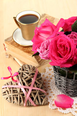 Beautiful pink roses in vase on wooden table close-up
