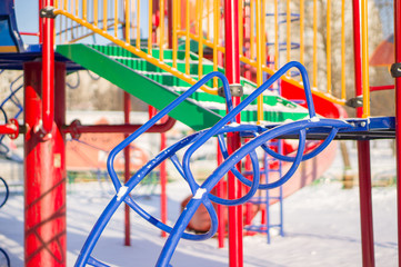 Climbing and crawling constructions on winter playground covered