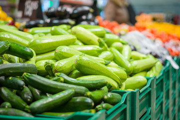 Bunch of Zucchini on boxes in supermarket