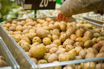 Customer select potatoes in supermarket