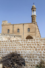 High bell tower on the church in Midyat, Turkey