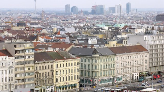 Viennese Danube tower stands against city landscape above roofs