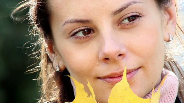 autumnal mood,beautiful woman holding leaves,
