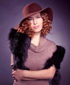 Red haired woma wearing elegant brown felt hat